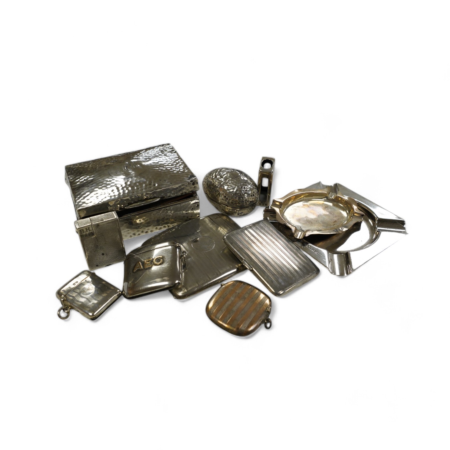 Eleven smoking related items including four silver vesta cases, one egg shaped, two silver ashtrays, two silver cigarette cases, a cigarette box, silver match sleeve and a silver plated Dunhill lighter. Condition - poor